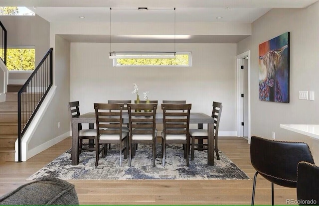 387 Bear Trl, Winter Park, CO 80482 - dining area with wood finished floors, stairs, and healthy amount of natural light