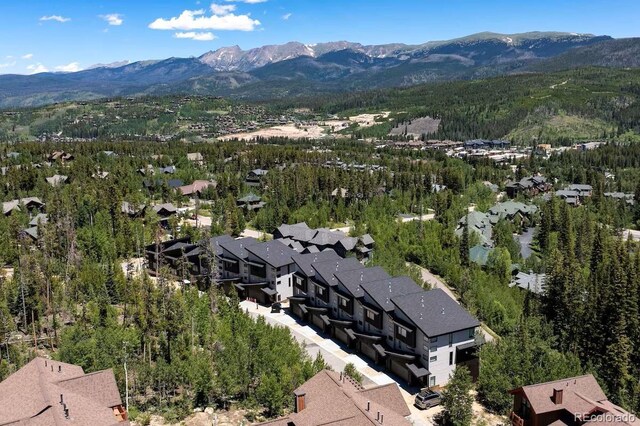 387 Bear Trl, Winter Park, CO 80482 - aerial view of residential area with a mountainous background and a heavily wooded area