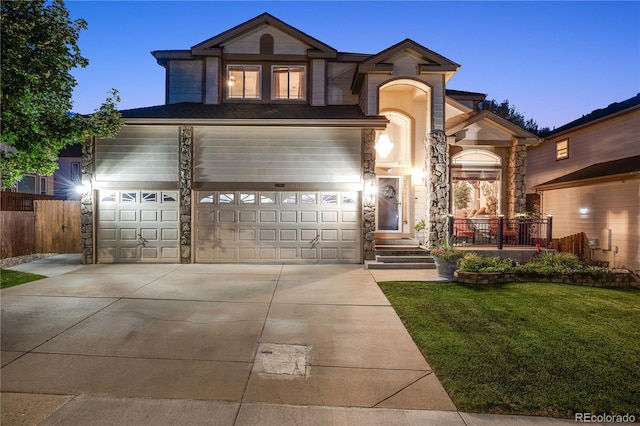 view of front of house featuring a garage and a lawn