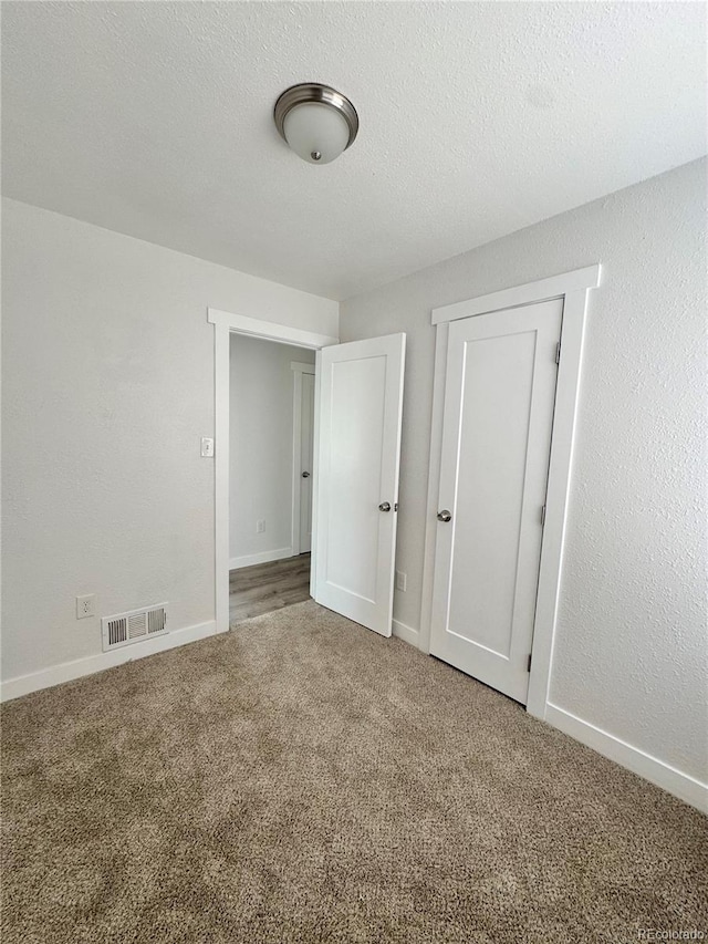unfurnished bedroom featuring carpet floors and baseboards