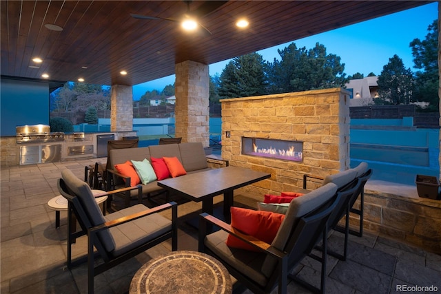15902 W 64th Ave, Arvada, CO 80007 - view of patio / terrace with an outdoor kitchen, fence, an outdoor living space with a fireplace, and area for grilling