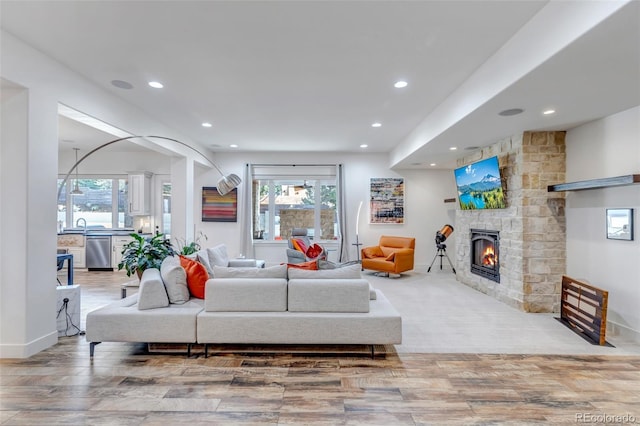 15902 W 64th Ave, Arvada, CO 80007 - living area with recessed lighting, a large fireplace, wood finished floors, and healthy amount of natural light