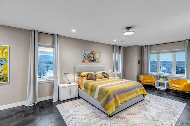 15902 W 64th Ave, Arvada, CO 80007 - bedroom with multiple windows, baseboards, recessed lighting, and dark tile patterned flooring