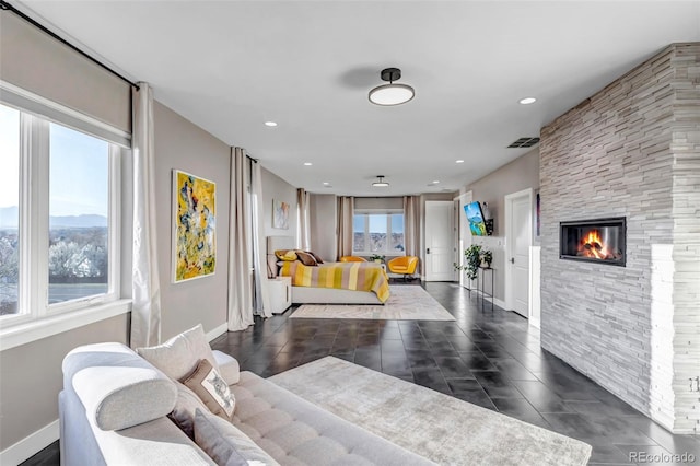 15902 W 64th Ave, Arvada, CO 80007 - living area with baseboards, dark tile patterned floors, recessed lighting, and a stone fireplace