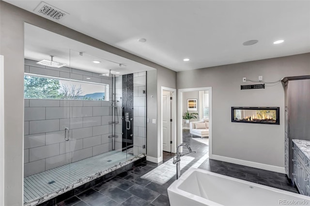 15902 W 64th Ave, Arvada, CO 80007 - full bathroom with a stall shower, a freestanding tub, recessed lighting, baseboards, and tile patterned flooring