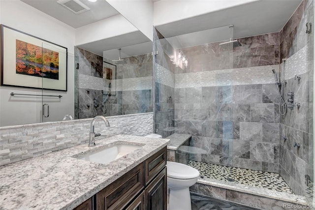 15902 W 64th Ave, Arvada, CO 80007 - bathroom with toilet, a shower stall, vanity, and backsplash