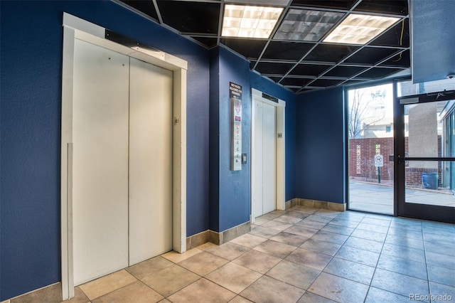 interior space with elevator and a wall of windows