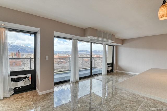 unfurnished room with a mountain view and cooling unit