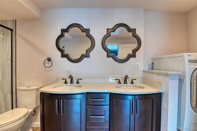 bathroom featuring vanity, washer / clothes dryer, and toilet