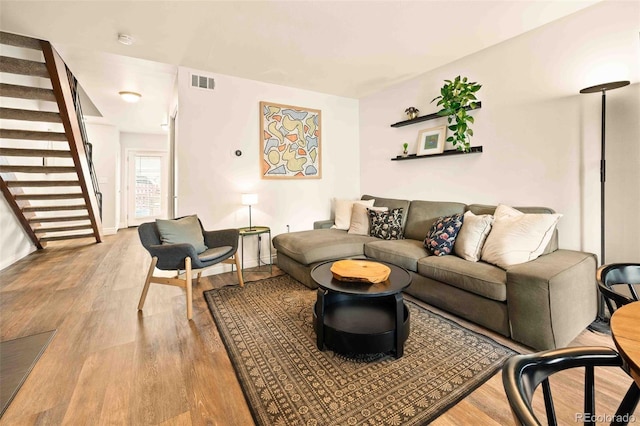 1150 Inca St Unit 39, Denver, CO 80204 - living area with stairway, wood finished floors, and baseboards
