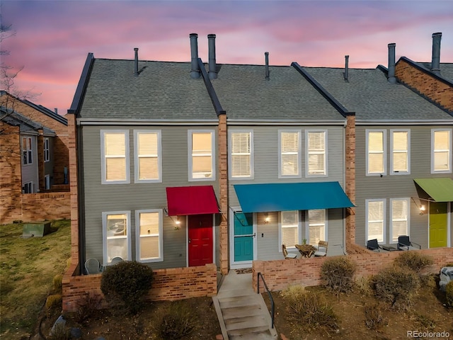 1150 Inca St Unit 39, Denver, CO 80204 - view of property featuring a shingled roof