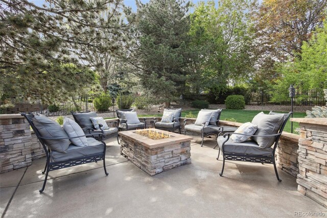 view of patio / terrace with fence and an outdoor living space with a fire pit