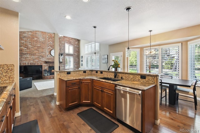 14417 W 57th Pl, Arvada, CO 80002 - kitchen with a sink, stainless steel dishwasher, dark wood-style flooring, brown cabinets, and a textured ceiling