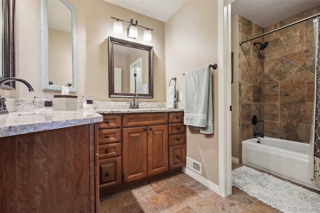 14417 W 57th Pl, Arvada, CO 80002 - full bath with baseboards, shower / tub combination, vanity, and stone finish flooring