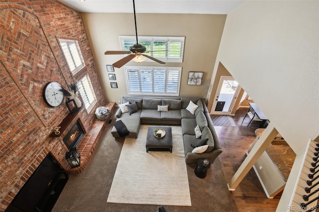 14417 W 57th Pl, Arvada, CO 80002 - living area featuring a high ceiling, ceiling fan, and a fireplace