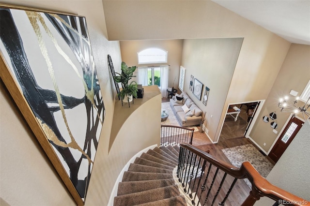 14417 W 57th Pl, Arvada, CO 80002 - stairs with high vaulted ceiling, wood finished floors, and baseboards