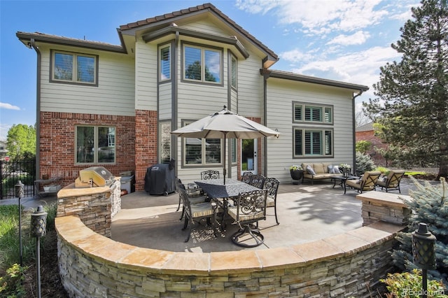 14417 W 57th Pl, Arvada, CO 80002 - back of house with a patio area, an outdoor hangout area, brick siding, and fence