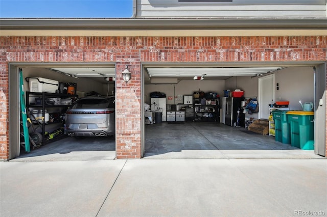 14417 W 57th Pl, Arvada, CO 80002 - garage featuring concrete driveway and freestanding refrigerator