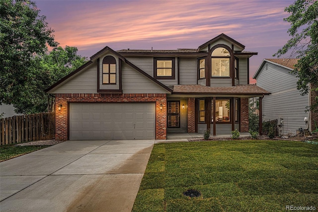 17548 E Wesley Pl, Aurora, CO 80013 - view of front of home with covered porch, concrete driveway, brick siding, a garage, and roof with shingles
