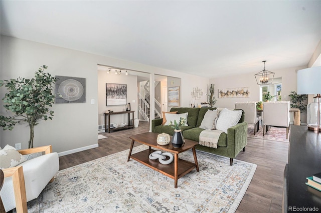 17548 E Wesley Pl, Aurora, CO 80013 - living area with wood finished floors, stairs, and a chandelier