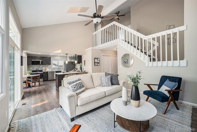 17548 E Wesley Pl, Aurora, CO 80013 - living room featuring high vaulted ceiling, dark wood finished floors, a ceiling fan, and stairs