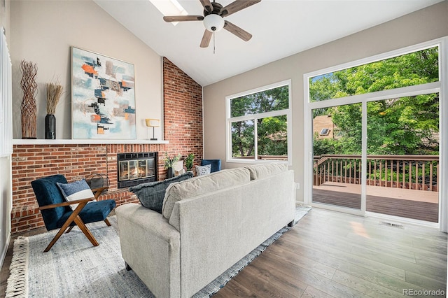 17548 E Wesley Pl, Aurora, CO 80013 - living room featuring wood finished floors, lofted ceiling, ceiling fan, and a fireplace