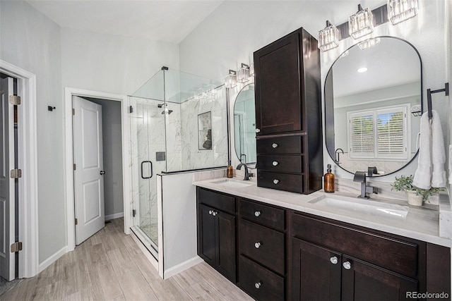 17548 E Wesley Pl, Aurora, CO 80013 - bathroom with a shower stall, double vanity, and wood finished floors