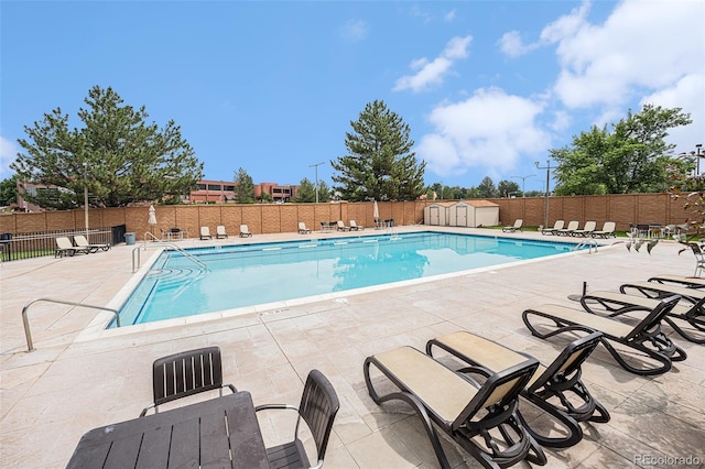 17548 E Wesley Pl, Aurora, CO 80013 - community pool featuring a patio and a storage unit