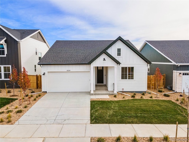 modern farmhouse style home featuring a front yard and a garage