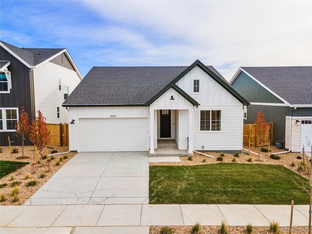 9314 Quartz St, Arvada, CO 80007 - modern inspired farmhouse with board and batten siding, an attached garage, concrete driveway, and a shingled roof