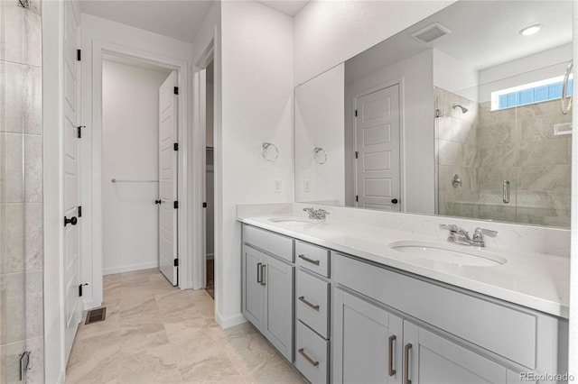 9314 Quartz St, Arvada, CO 80007 - full bathroom with a shower stall, double vanity, marble finish floors, and baseboards