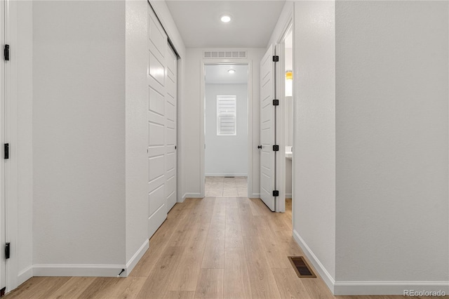 9314 Quartz St, Arvada, CO 80007 - corridor with light wood-style flooring, baseboards, and recessed lighting