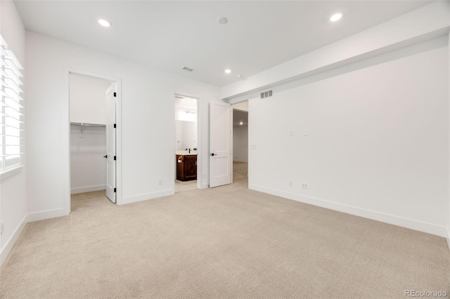 6677 Crossbridge Cir, Castle Pines, CO 80108 - unfurnished bedroom with light carpet, a spacious closet, recessed lighting, and baseboards