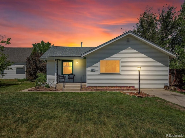 6801 W 52nd Ave, Arvada, CO 80002 - view of front of property featuring covered porch, a front lawn, and roof with shingles