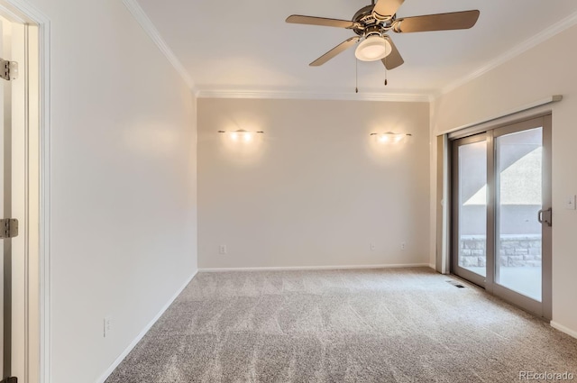 carpeted spare room featuring ceiling fan and crown molding