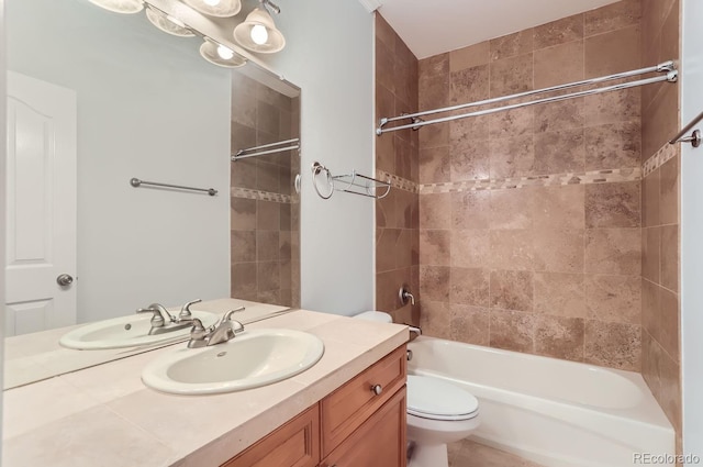 full bathroom featuring vanity, toilet, and tiled shower / bath