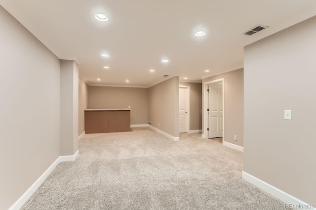 basement featuring light colored carpet