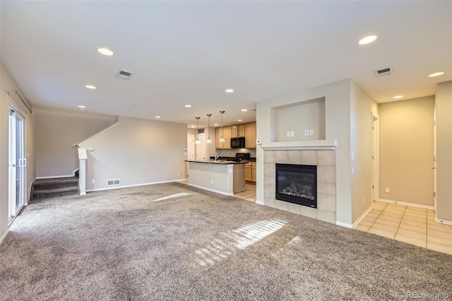 unfurnished living room with light carpet and a fireplace