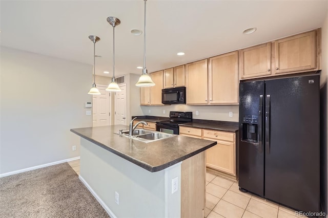 kitchen featuring black appliances, light brown cabinetry, a kitchen island with sink, sink, and decorative light fixtures