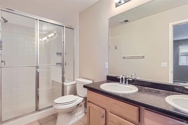 bathroom featuring an enclosed shower, vanity, toilet, and tile patterned flooring