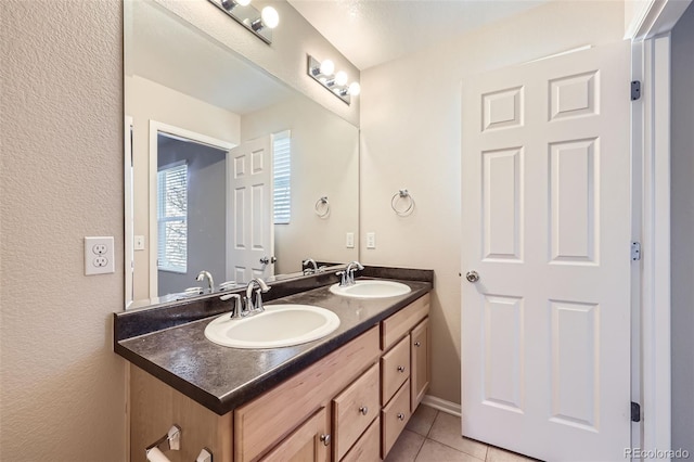 bathroom with tile patterned flooring and vanity