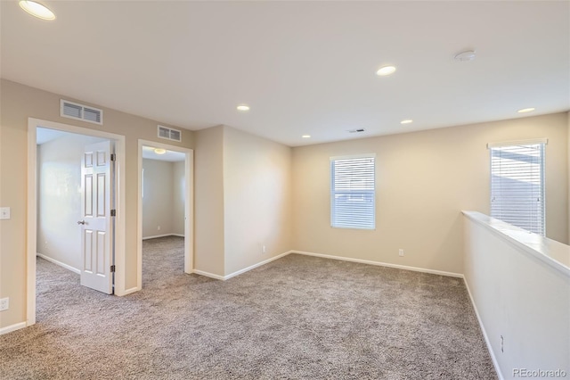 empty room featuring carpet and plenty of natural light