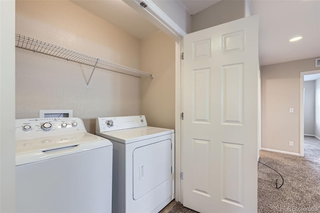 clothes washing area with separate washer and dryer and carpet