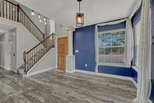 3630 Sawgrass Trl, Castle Rock, CO 80109 - foyer featuring ornate columns, wood finished floors, stairway, baseboards, and a textured wall