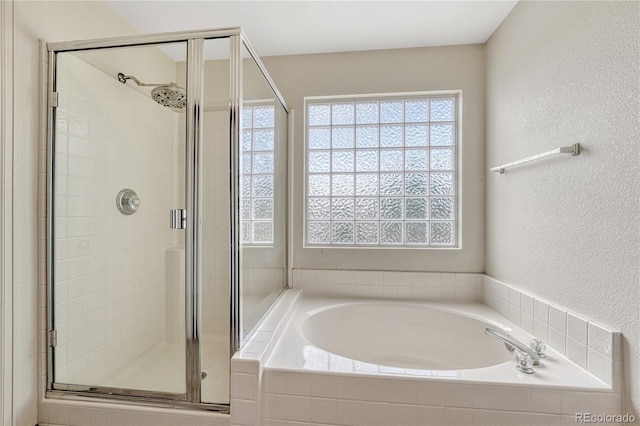 3630 Sawgrass Trl, Castle Rock, CO 80109 - full bathroom featuring plenty of natural light, a shower stall, and a garden tub
