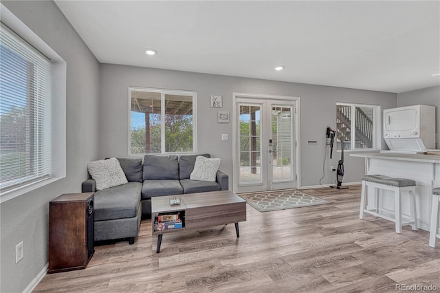 3630 Sawgrass Trl, Castle Rock, CO 80109 - living area featuring stacked washing machine and dryer, light wood finished floors, baseboards, and recessed lighting