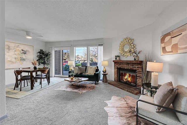 living room with dark colored carpet, a fireplace, ceiling fan, and a textured ceiling