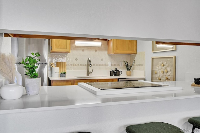 kitchen with decorative backsplash, stainless steel fridge, an AC wall unit, and sink