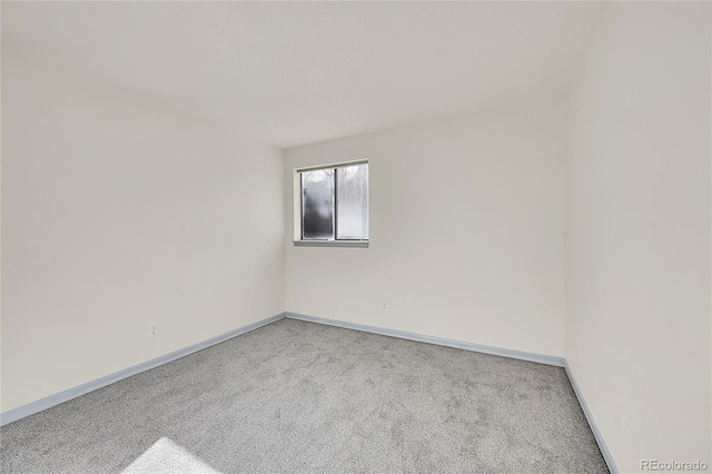 spare room with light colored carpet