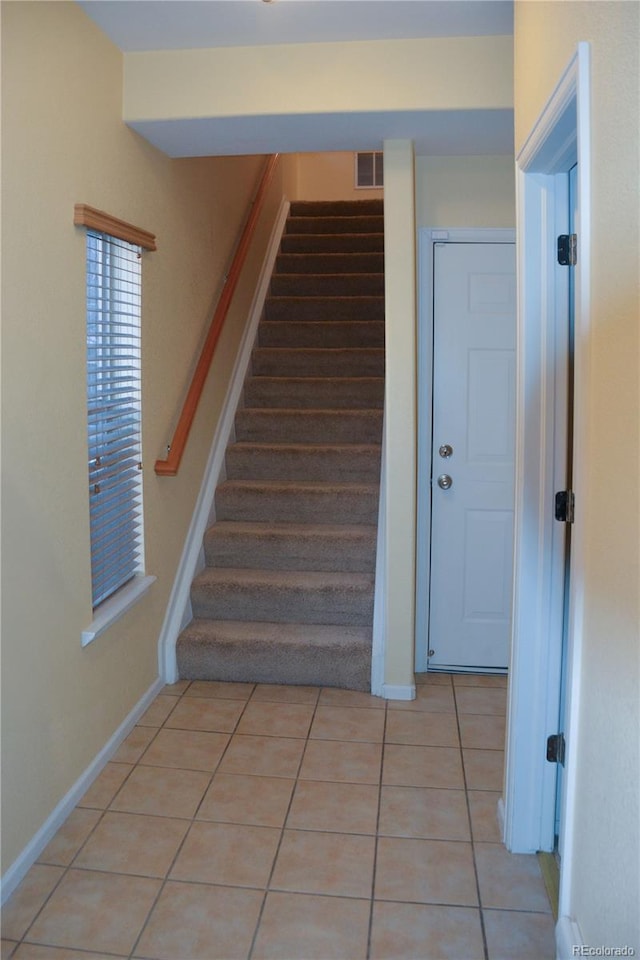 stairs featuring tile patterned floors